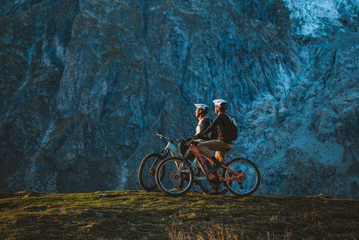 MTB kolesarja občudujeta razgled na gore.